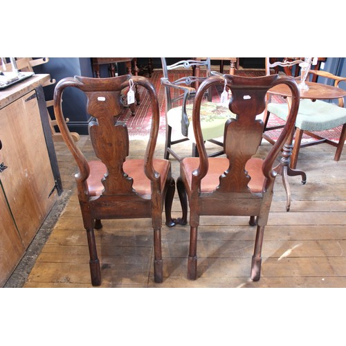 678 - A pair of George I walnut side chairs, each with a vase shaped splat over a drop in upholstered seat... 