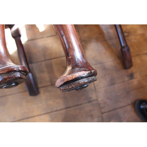 678 - A pair of George I walnut side chairs, each with a vase shaped splat over a drop in upholstered seat... 