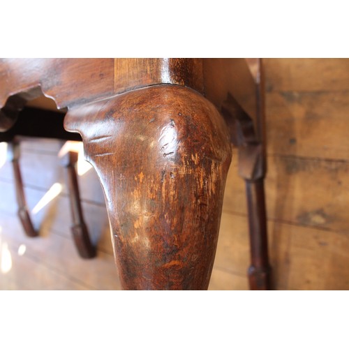 678 - A pair of George I walnut side chairs, each with a vase shaped splat over a drop in upholstered seat... 