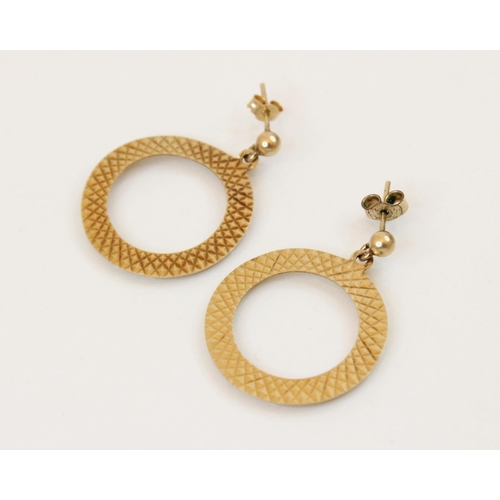 106 - A pair of vintage 9ct gold drop earrings, each designed as a circular hoop with engine turned decora... 