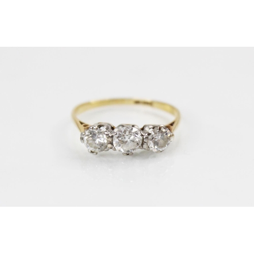 119 - A diamond three stone ring, comprising a central round brilliant cut diamond (weighing approximately... 