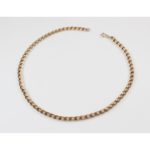 120 - A yellow metal curb link chain, with spring ring and loop fastener, marked '9ct', 41.3cm long, weigh... 