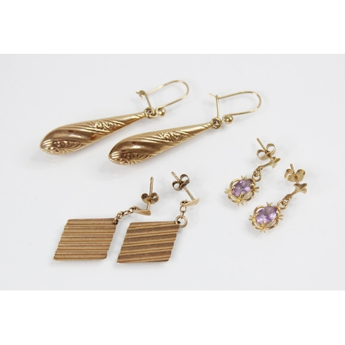 123 - A pair of torpedo-shaped drop earrings, each designed as a tapered baton with engraved floral decora... 