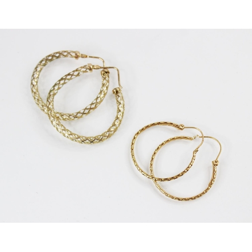 124 - A pair of 9ct gold hoop earrings, each of circular form with a pierced design frame, hinged back fas... 