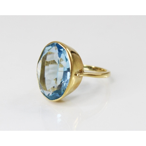 127 - An 18ct gold paste set cocktail ring, the central oval mixed cut blue paste (measuring 20mm x 14mm),... 