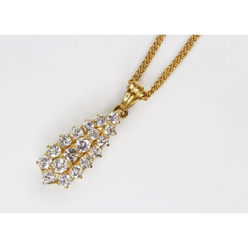 128 - A diamond teardrop pendant, comprising eighteen round brilliant cut diamonds, with an estimated diam... 