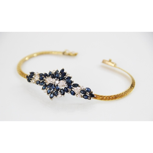 130 - A sapphire and diamond bracelet, designed as an abstract cluster set with thirty-four marquise shape... 