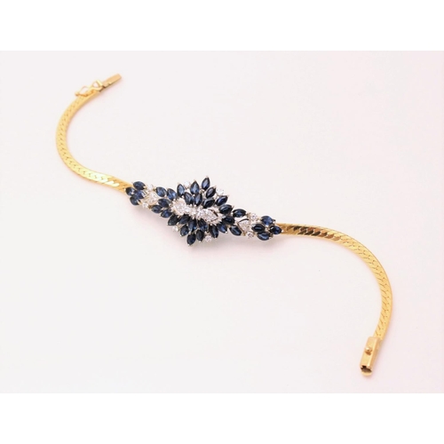 130 - A sapphire and diamond bracelet, designed as an abstract cluster set with thirty-four marquise shape... 