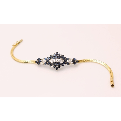 130 - A sapphire and diamond bracelet, designed as an abstract cluster set with thirty-four marquise shape... 