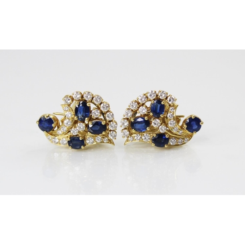 134 - A pair of sapphire and diamond spray earrings by Gazdar, each comprising three oval mixed cut sapphi... 