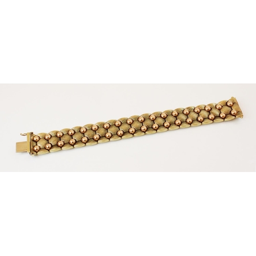 147 - A 1970's 9ct gold bracelet, comprising brushed yellow gold articulated links interspersed with plain... 