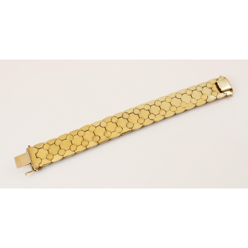 147 - A 1970's 9ct gold bracelet, comprising brushed yellow gold articulated links interspersed with plain... 