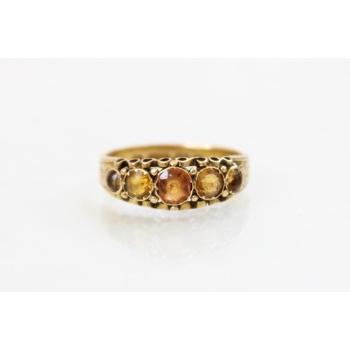 149 - A Victorian 15ct gold five stone ring, comprising a central round mixed cut hessonite garnet (measur... 