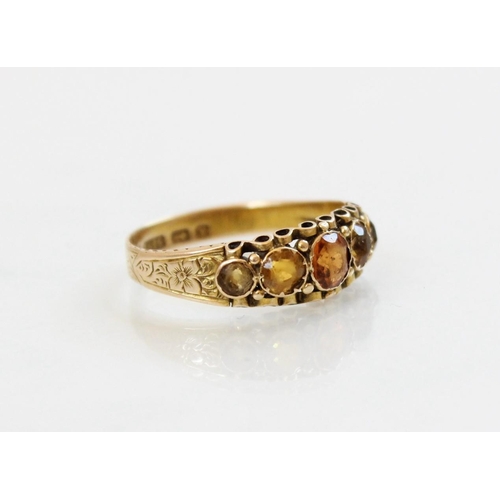 149 - A Victorian 15ct gold five stone ring, comprising a central round mixed cut hessonite garnet (measur... 