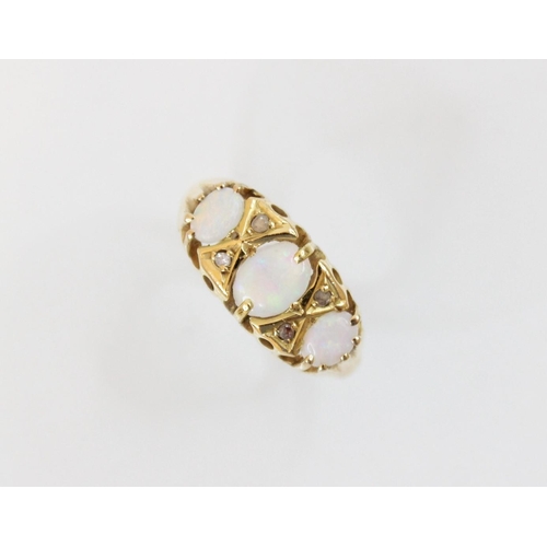 150 - An opal and diamond 18ct gold ring, comprising a central polished oval opal cabochon (measuring 6.1m... 