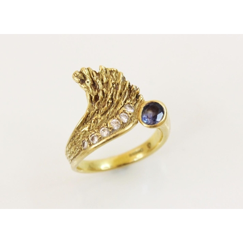 151 - A sapphire and diamond 18ct gold ring, designed as an open wing, set with an oval mixed cut sapphire... 