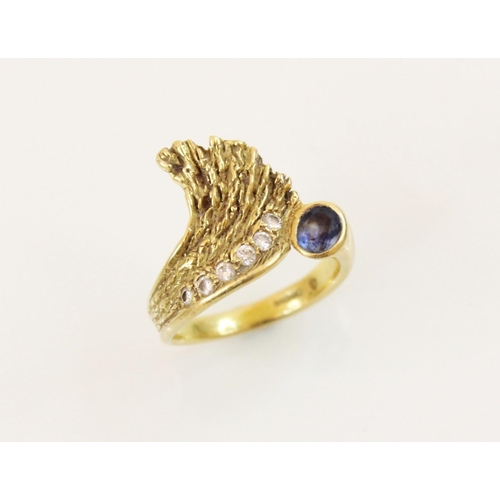 151 - A sapphire and diamond 18ct gold ring, designed as an open wing, set with an oval mixed cut sapphire... 