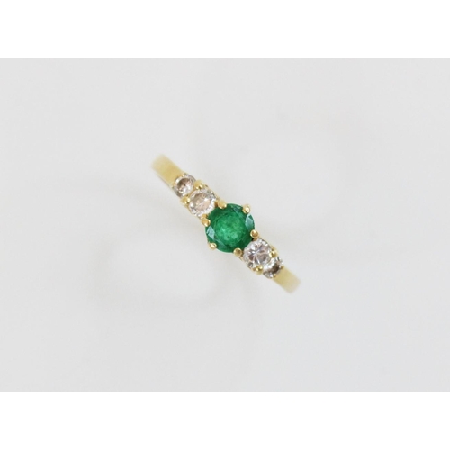 152 - An emerald and diamond 18ct gold ring, the central round mixed cut emerald (measuring 5mm diameter),... 