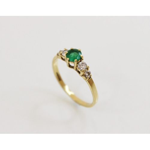 152 - An emerald and diamond 18ct gold ring, the central round mixed cut emerald (measuring 5mm diameter),... 