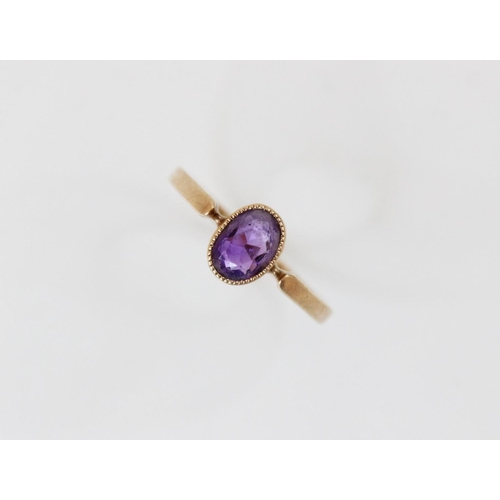 162 - A late Edwardian amethyst set 9ct gold ring, the central oval mixed cut amethyst (measuring 6.5mm x ... 