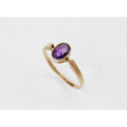 162 - A late Edwardian amethyst set 9ct gold ring, the central oval mixed cut amethyst (measuring 6.5mm x ... 