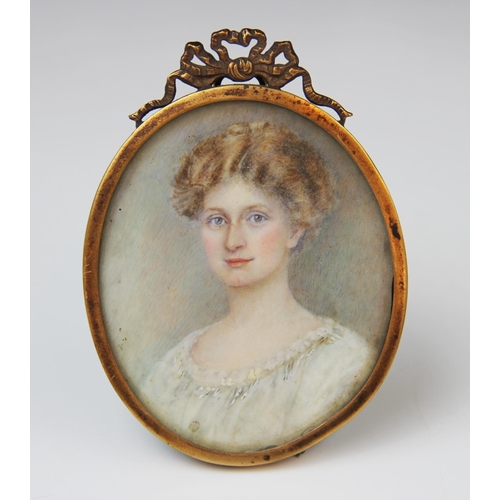 174 - A George V portrait miniature on ivory, early 20th century, depicting a bust length portrait of a la... 