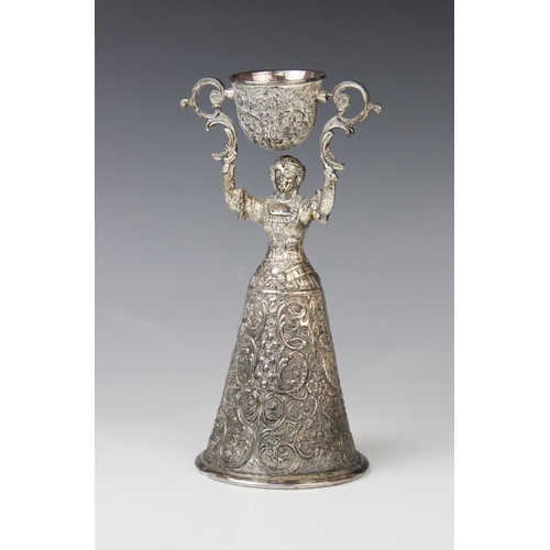 2 - A continental silver plated wager cup, in the form of a finely dressed lady with full skirt holding ... 