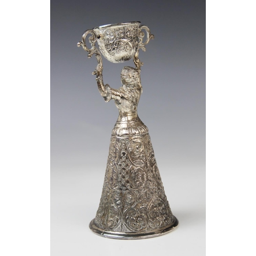2 - A continental silver plated wager cup, in the form of a finely dressed lady with full skirt holding ... 