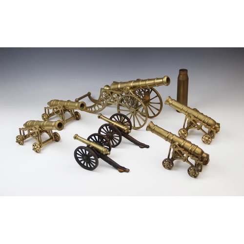 202 - A collection of cast brass table top model cannon, 20th century, the largest raised on two wheels wi... 