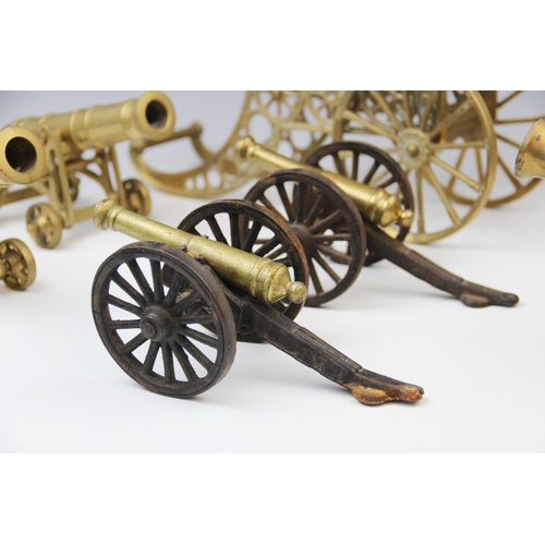 202 - A collection of cast brass table top model cannon, 20th century, the largest raised on two wheels wi... 