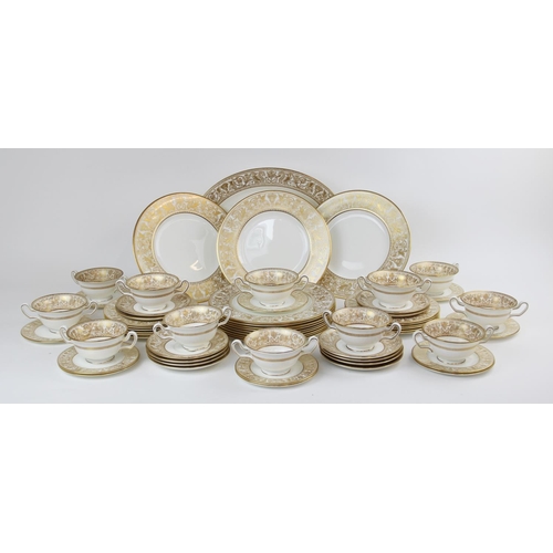 215 - A Wedgwood 'Gold Florentine' part dinner service, W4219, comprising: a meat plate, twelve dinner pla... 