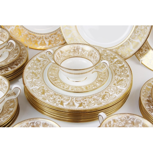 215 - A Wedgwood 'Gold Florentine' part dinner service, W4219, comprising: a meat plate, twelve dinner pla... 