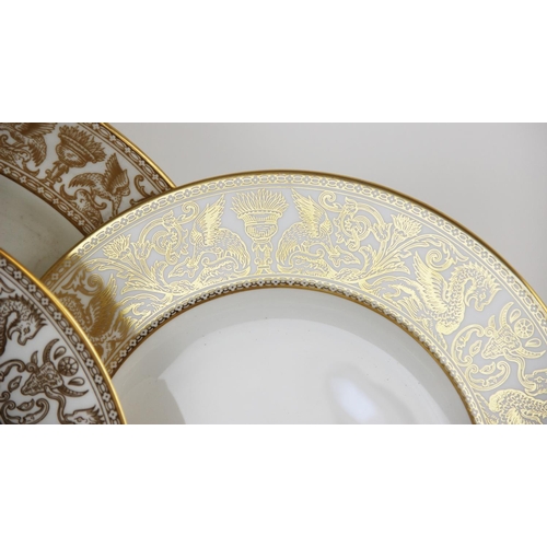 215 - A Wedgwood 'Gold Florentine' part dinner service, W4219, comprising: a meat plate, twelve dinner pla... 