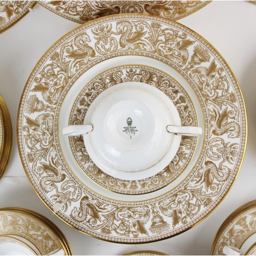 215 - A Wedgwood 'Gold Florentine' part dinner service, W4219, comprising: a meat plate, twelve dinner pla... 