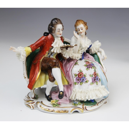 228 - A Volkstedt porcelain figural group, mid 20th century, modelled as a gentleman reading to a lady, 14... 