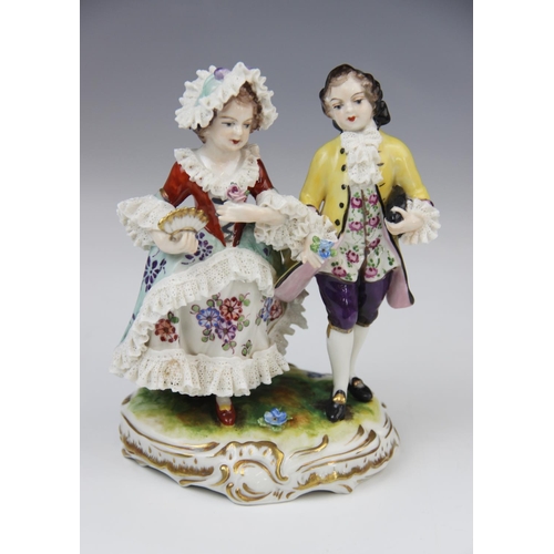 228 - A Volkstedt porcelain figural group, mid 20th century, modelled as a gentleman reading to a lady, 14... 