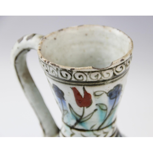 241 - An Ottoman Empire Turkish polychrome pottery jug, of pear shape with attached handle and flared neck... 