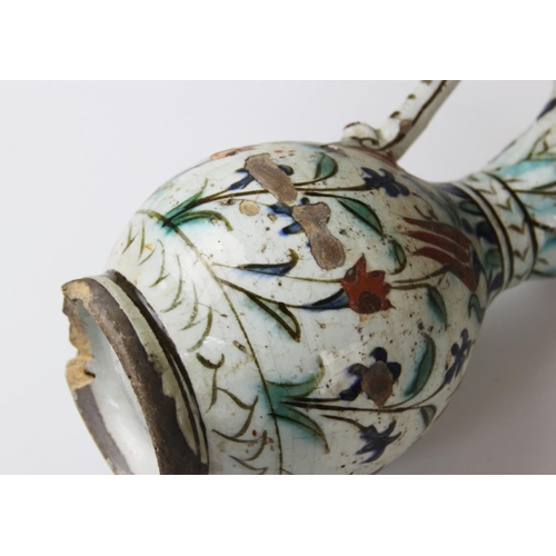 241 - An Ottoman Empire Turkish polychrome pottery jug, of pear shape with attached handle and flared neck... 