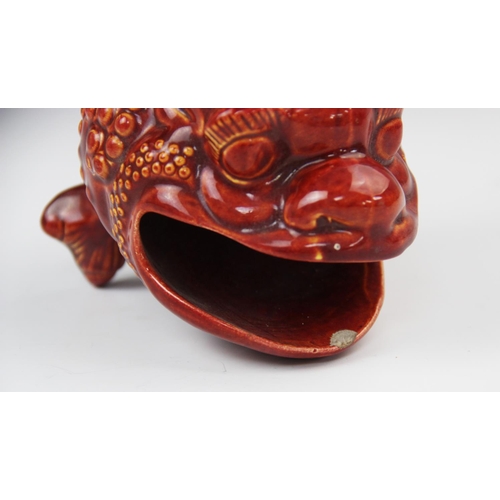 242 - A Burmantofts faience spoon warmer, modelled as a grotesque bull frog in a burnt red/orange glaze, i... 