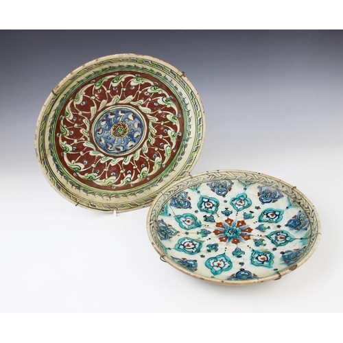 243 - Two 17th century Ottoman Empire Turkish polychrome pottery wares, comprising: a charger, 29.5cm diam... 