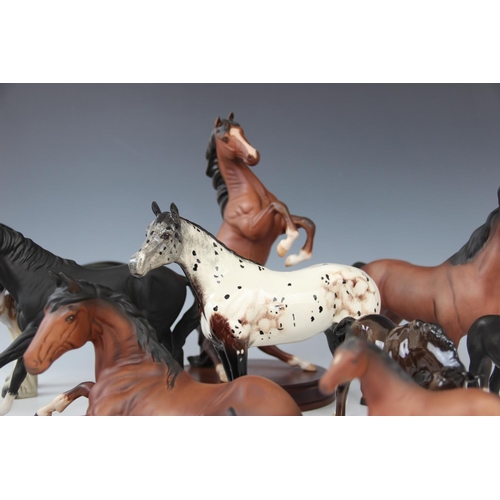 246 - A Beswick Appaloosa stallion, 20cm high, with a collection of Royal Doulton horses, to include 'Spir... 