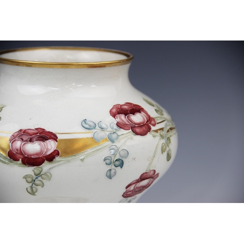 247 - A pair of William Moorcroft for James Macintyre & Co vases, early 20th century, each of compressed b... 