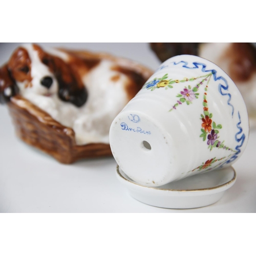 252 - Three Royal Doulton dog groups, comprising: HN2585 spaniel in a basket, HN1029 spaniel with pheasant... 