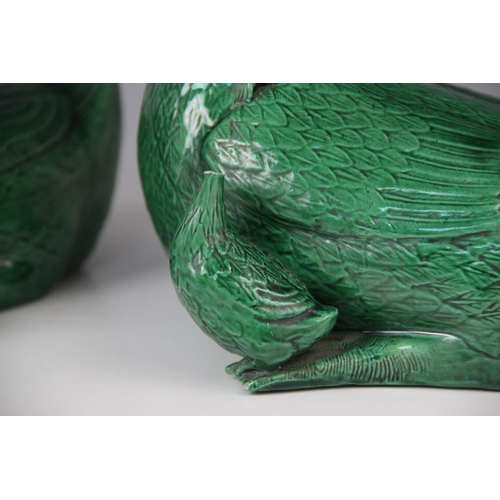 272 - A pair of Chinese porcelain green glazed ducks, early 20th century, each modelled with two ducklings... 