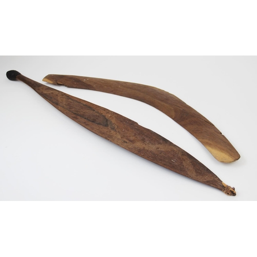 311 - A large Australian Aboriginal spear thrower with carved decoration, 83cm long, along with a boomeran... 