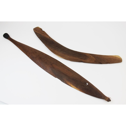 311 - A large Australian Aboriginal spear thrower with carved decoration, 83cm long, along with a boomeran... 