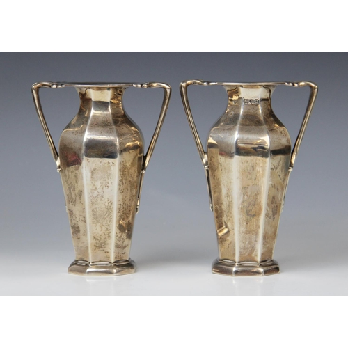 35 - A pair of Edwardian silver twin-handled vases by Goldsmiths & Silversmiths Company, London 1909, eac... 