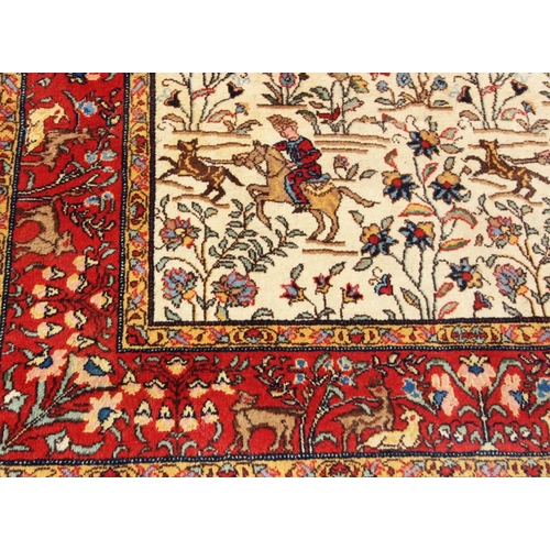 398 - A Persian wool carpet, with an all-over warring scene with Persian warriors on horseback, 280cm x 16... 