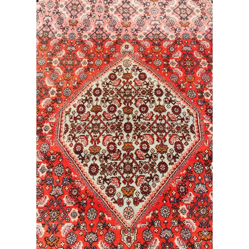 399 - A Turkish village wool rug, with a traditional lozenge design wit extensive geometric motifs against... 