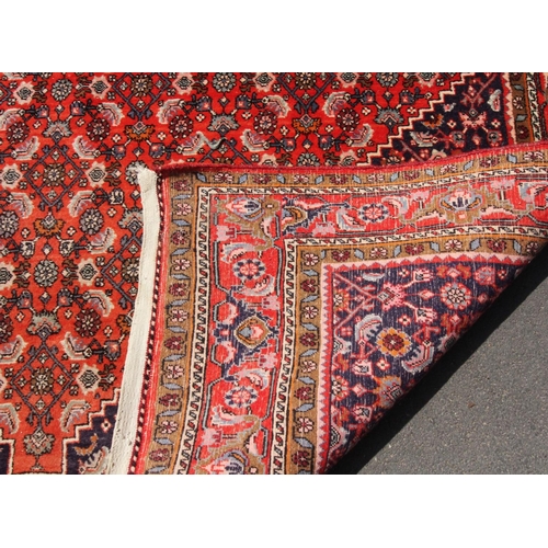 399 - A Turkish village wool rug, with a traditional lozenge design wit extensive geometric motifs against... 